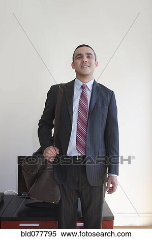 Hispanic businessman carrying duffle bag View Large Photo Image Stock Photography - Hispanic businessman carrying duffle bag. Fotosearch