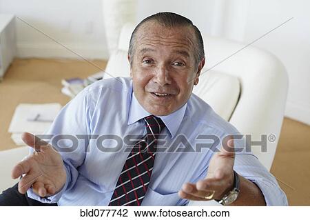 Stock Image - Hispanic businessman shrugging. Fotosearch