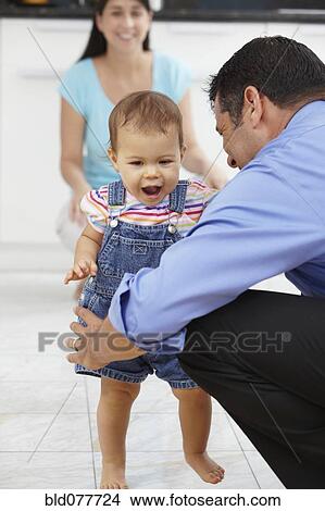 Picture - Hispanic father playing with daughter. Fotosearch