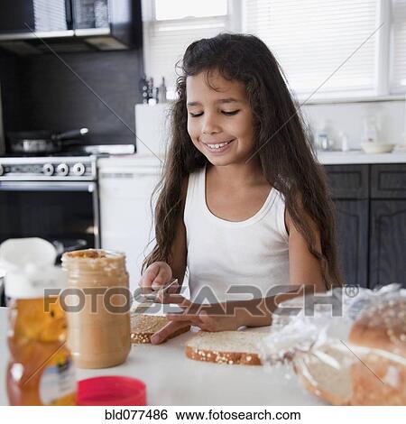 Hispanic girl making peanut butter sandwich View Large Photo Image Stock Photograph - Hispanic girl making peanut butter sandwich. Fotosearch