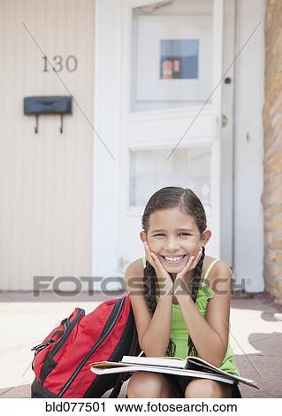 Hispanic girl sitting with school books on front stoop View Large Photo Image Stock Image - Hispanic girl sitting with school books on front stoop. Fotosearch