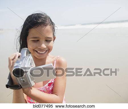 Hispanic girl using video camera View Large Photo Image Stock Photography - Hispanic girl using video camera. Fotosearch
