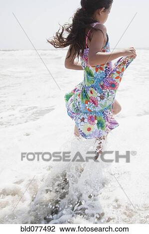 Hispanic girl wading on ocean View Large Photo Image Stock Image - Hispanic girl wading on ocean. Fotosearch