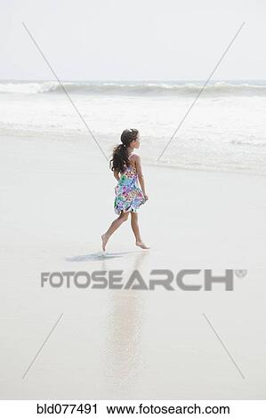 Hispanic girl walking on beach View Large Photo Image Stock Image - Hispanic girl walking on beach. Fotosearch