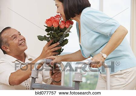 Hispanic man bring wife flowers View Large Photo Image Stock Photo - Hispanic man bring wife flowers. Fotosearch