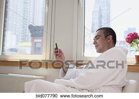 Hispanic man text messaging with cell phone View Large Photo Image Stock Image - Hispanic man text messaging with cell phone. Fotosearch