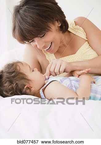 Hispanic mother bonding with daughter View Large Photo Image Stock Photo - Hispanic mother bonding with daughter. Fotosearch