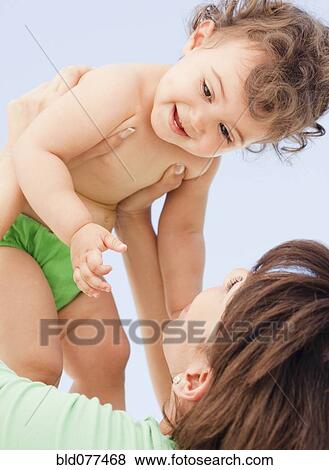 Hispanic mother playing with daughter View Large Photo Image Stock Photo - Hispanic mother playing with daughter. Fotosearch