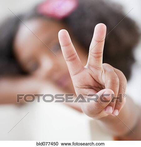 Mixed race girl making the peace symbol View Large Photo Image Stock Image - Mixed race girl making the peace symbol. Fotosearch