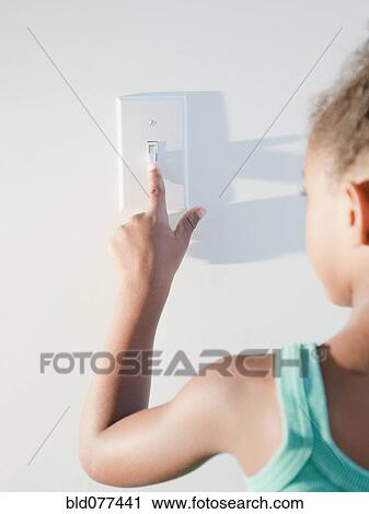 Mixed race girl turning off light View Large Photo Image Stock Image - Mixed race girl turning off light. Fotosearch
