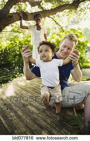 Multi-ethnic family enjoying garden View Large Photo Image Stock Photograph - Multi-ethnic family enjoying garden. Fotosearch