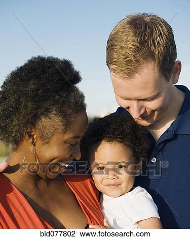 Stock Image - Multi-ethnic family smiling. Fotosearch