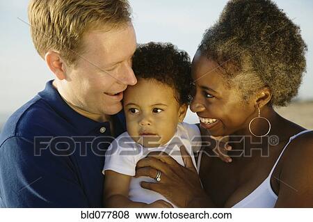 Multi-ethnic family smiling View Large Photo Image Stock Photo - Multi-ethnic family smiling. Fotosearch