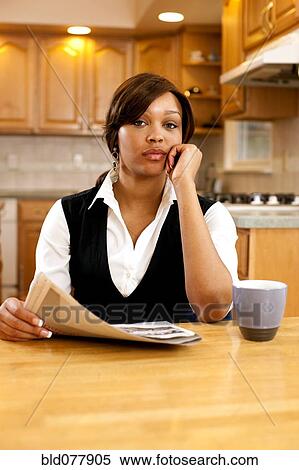 Serious African woman with paperwork and coffee in kitchen View Large Photo Image Stock Photography - Serious African woman with paperwork and coffee in kitchen. Fotosearch