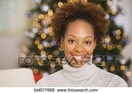 Stock Photo - Smiling African woman at Christmas. Fotosearch