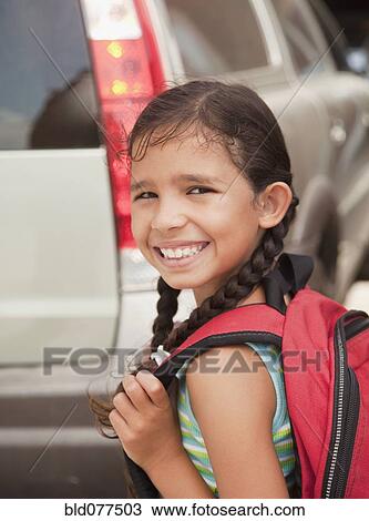 Smiling Hispanic girl carrying backpack View Large Photo Image Stock Image - Smiling Hispanic girl carrying backpack. Fotosearch