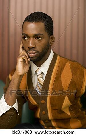 Well-dressed African man looking pensive View Large Photo Image Stock Photo - Well-dressed African man looking pensive. Fotosearch
