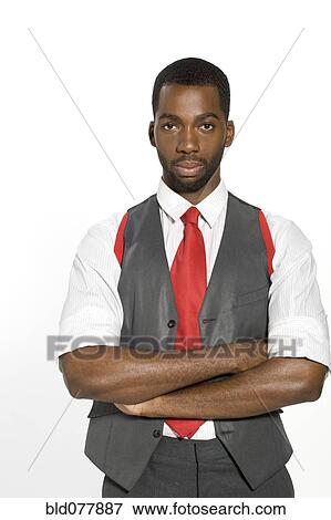 Stock Photo - Well-dressed African man with arms crossed. Fotosearch