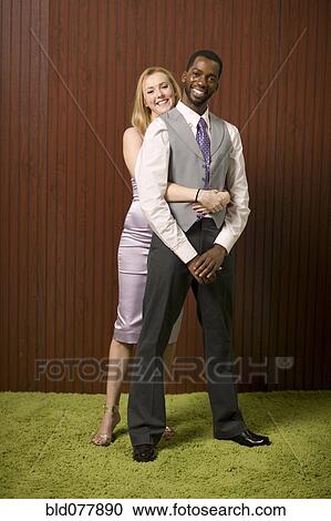 Well-dressed couple hugging View Large Photo Image Stock Image - Well-dressed couple hugging. Fotosearch