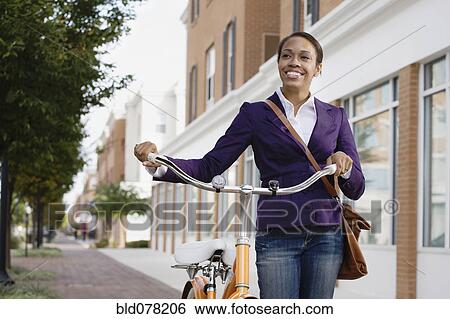 African American woman riding bicycle View Large Photo Image Stock Photograph - African American woman riding bicycle. Fotosearch