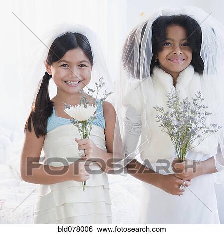 Girls dressing up in wedding dress View Large Photo Image Stock Photograph - Girls dressing up in wedding dress. Fotosearch