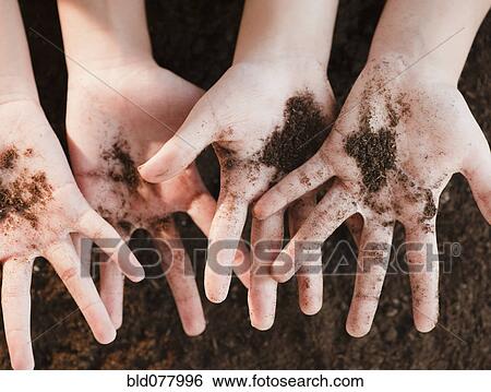 Girls holding dirt View Large Photo Image Stock Photograph - Girls holding dirt. Fotosearch