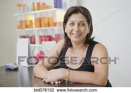 Hispanic beauty salon owner smiling View Large Photo Image Stock Image - Hispanic beauty salon owner smiling. Fotosearch