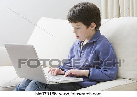 Hispanic boy using laptop View Large Photo Image Stock Photograph - Hispanic boy using laptop. Fotosearch