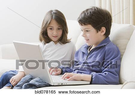 Hispanic brother and sister using laptop View Large Photo Image Stock Photography - Hispanic brother and sister using laptop. Fotosearch