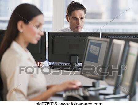 Stock Photography - Hispanic businessman working on computer. Fotosearch