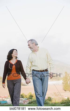 Stock Image - Hispanic couple holding hands. Fotosearch