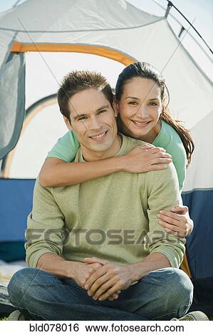 Hispanic couple hugging near tent View Large Photo Image Stock Photograph - Hispanic couple hugging near tent. Fotosearch