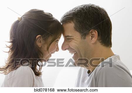 Stock Photo - Hispanic father and daughter smiling. Fotosearch