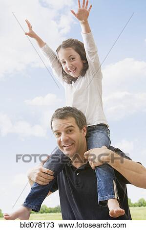 Hispanic father carrying daughter on shoulders View Large Photo Image Stock Image - Hispanic father carrying daughter on shoulders. Fotosearch