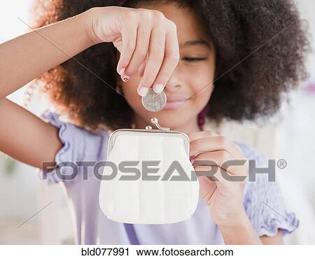 Hispanic girl putting coin into purse View Large Photo Image Stock Image - Hispanic girl putting coin into purse. Fotosearch