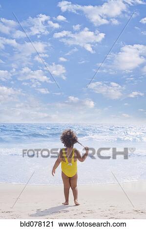 Hispanic girl standing on beach View Large Photo Image Stock Image - Hispanic girl standing on beach. Fotosearch