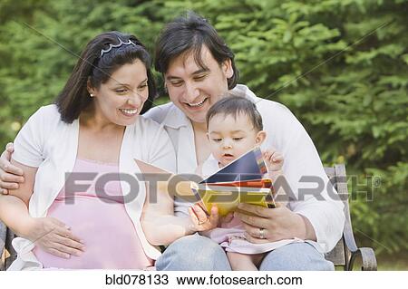 Hispanic mother and father reading to daughter View Large Photo Image Stock Image - Hispanic mother and father reading to daughter. Fotosearch