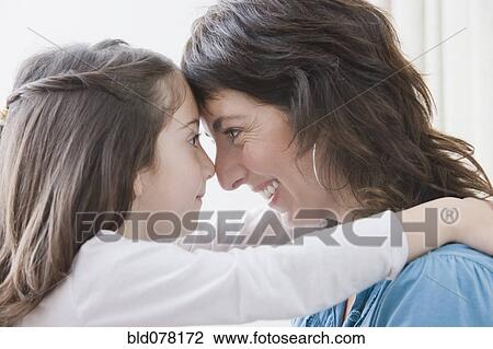 Hispanic mother hugging daughter View Large Photo Image Stock Image - Hispanic mother hugging daughter. Fotosearch