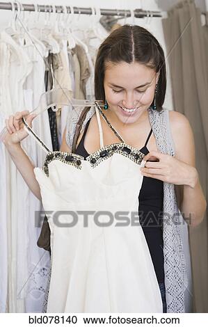 Stock Image - Hispanic woman shopping for wedding dress. Fotosearch