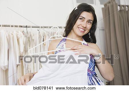 Hispanic woman shopping for wedding dress View Large Photo Image Stock Image - Hispanic woman shopping for wedding dress. Fotosearch