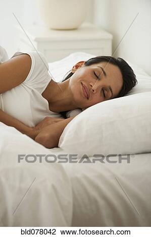 Hispanic woman sleeping in bed View Large Photo Image Stock Image - Hispanic woman sleeping in bed. Fotosearch