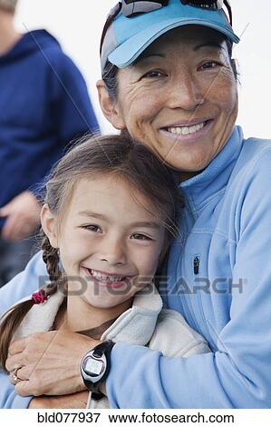 Stock Photo - Japanese mother and daughter hugging. Fotosearch