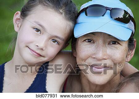 Stock Image - Japanese mother and daughter smiling. Fotosearch