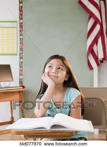 Mixed race girl daydreaming in classroom View Large Photo Image Stock Image - Mixed race girl daydreaming in classroom. Fotosearch