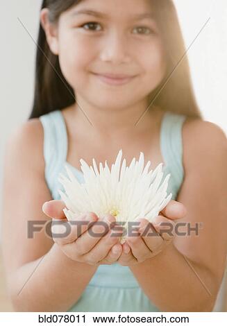 Mixed race girl holding flower View Large Photo Image Stock Image - Mixed race girl holding flower. Fotosearch