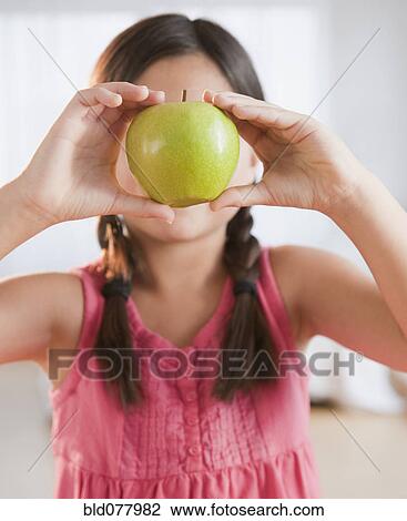 Mixed race girl holding green apple View Large Photo Image Stock Image - Mixed race girl holding green apple. Fotosearch