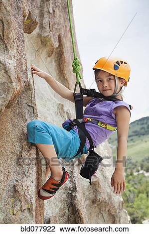 Mixed race girl rock climbing View Large Photo Image Stock Image - Mixed race girl rock climbing. Fotosearch