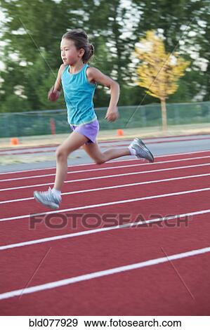 Stock Photo - Mixed race girl running on track. Fotosearch