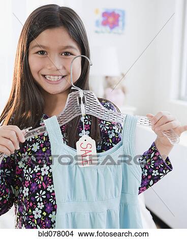 Mixed race girl shopping for dress View Large Photo Image Picture - Mixed race girl shopping for dress. Fotosearch