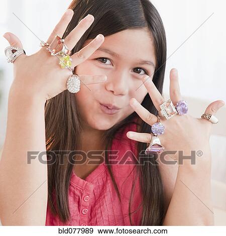 Mixed race girl wearing glamorous rings View Large Photo Image Stock Photo - Mixed race girl wearing glamorous rings. Fotosearch